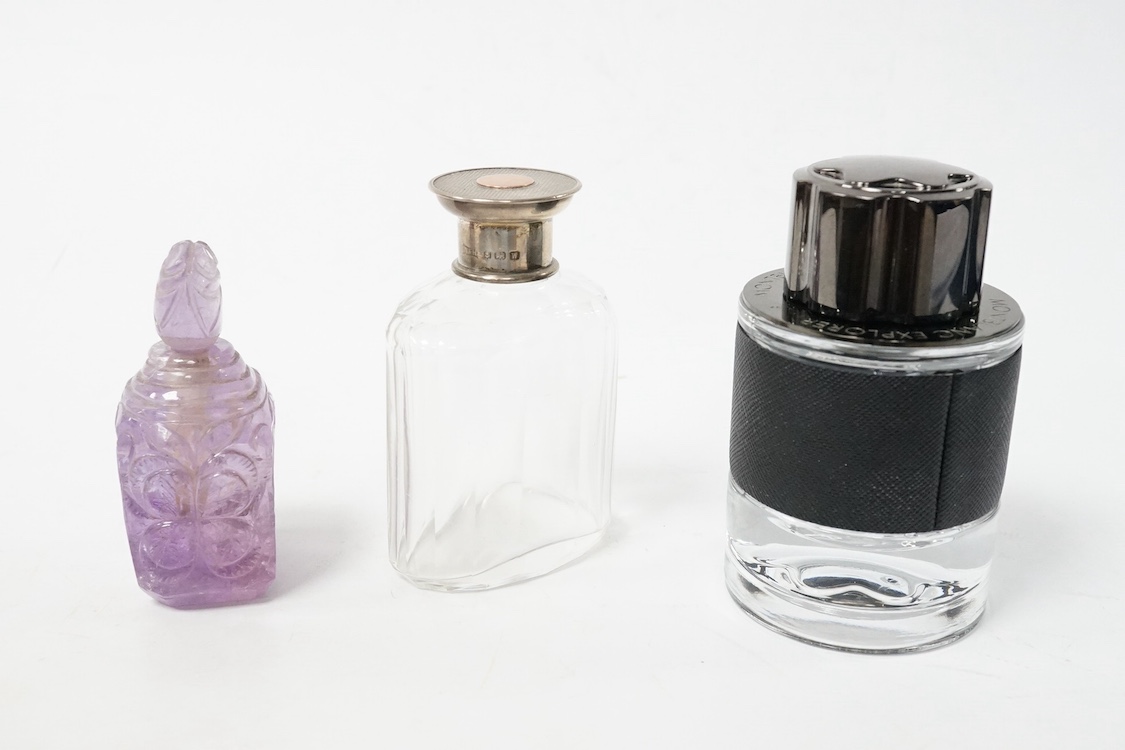 A Mont Blanc perfume bottle, 9.5cm high, an amethyst carved glass perfume bottle and a silver topped bottle. Condition - fair to good
